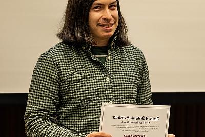 Fernando Zavala holding The First Year Student Award, presented to Fernando Zavala by Professor Meg Baronian.