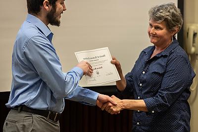 Professor Karina Assiter presenting the Computer Science Award to Student Andrew Barrows.