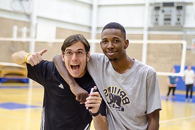 Two Landmark students pose for the camera during a volleyball game in the Click Family Athletic Center. 