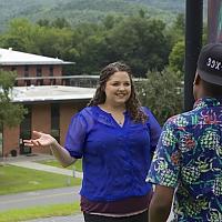 Rachel Brown stands on upper campus talking to another student